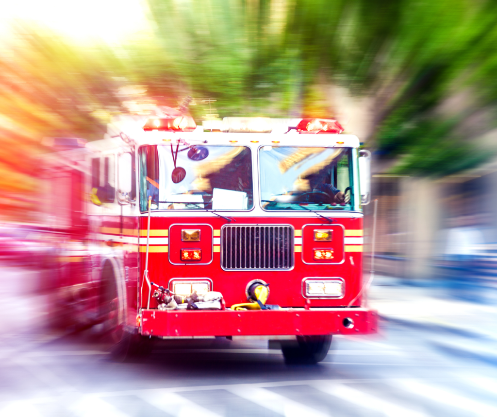 A red fire truck parked at the scene, ready for emergency firefighting operations